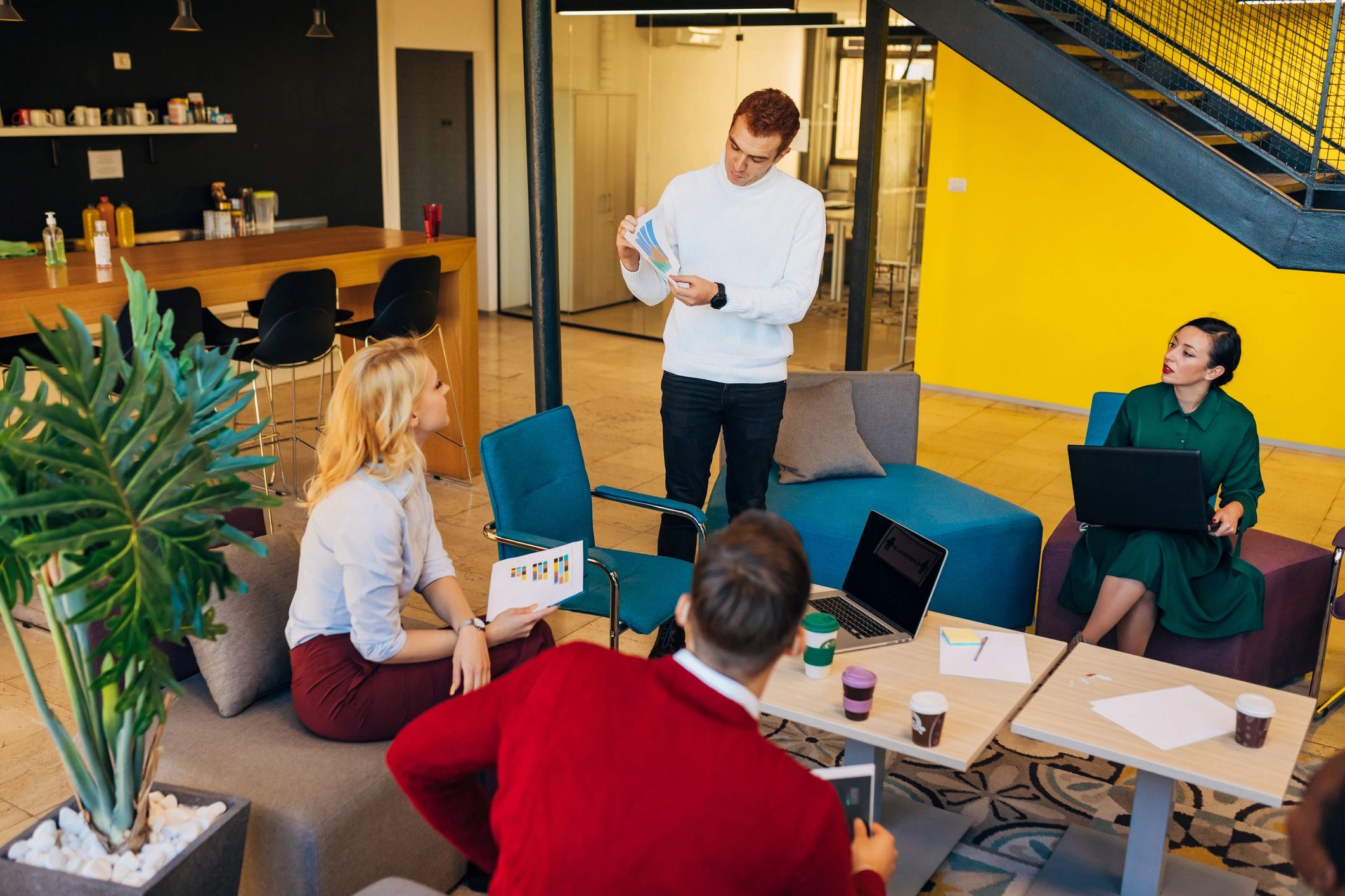 Team discussing numbers during a meeting in a modern office