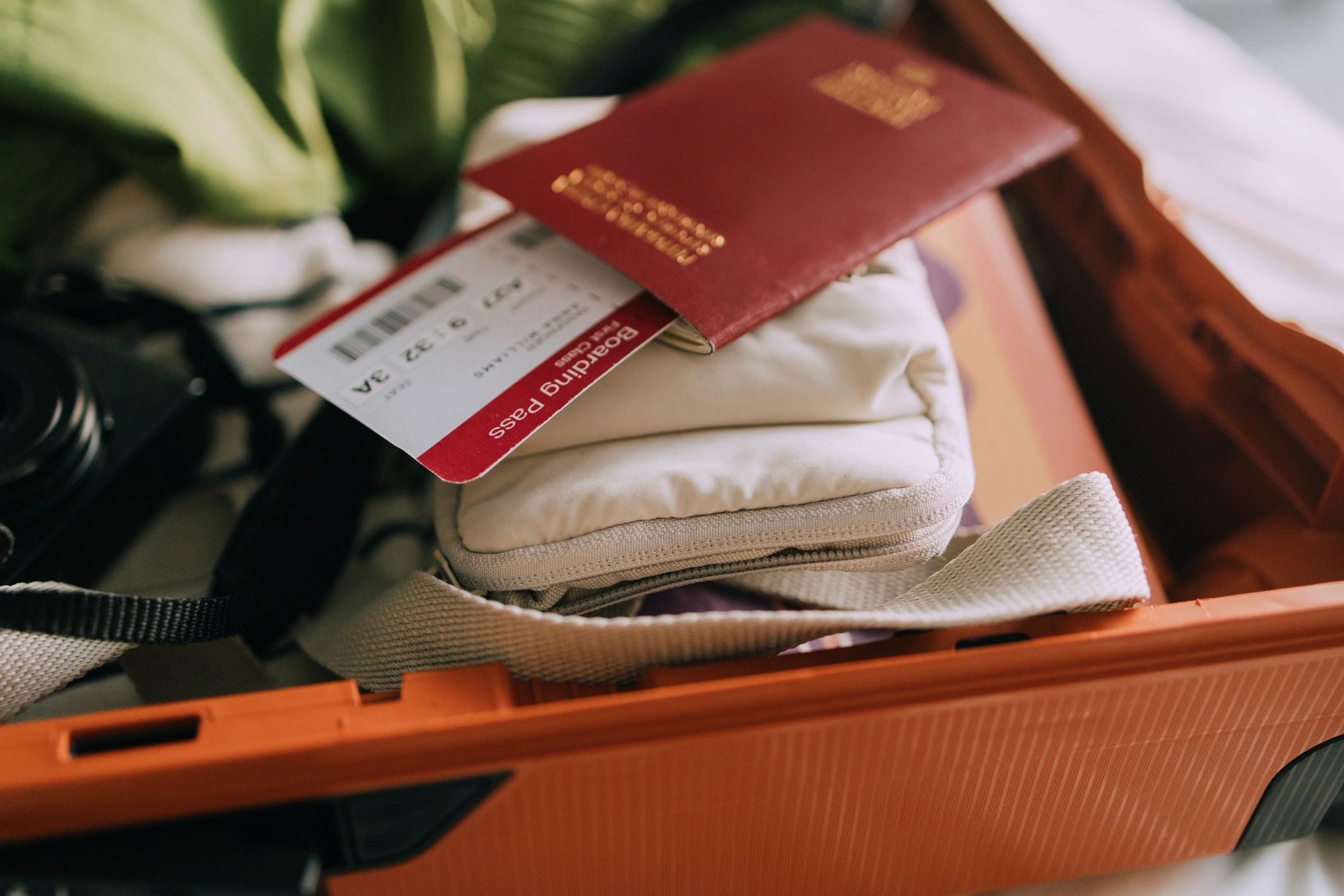 Passport and boarding pass in a packed suitcase
