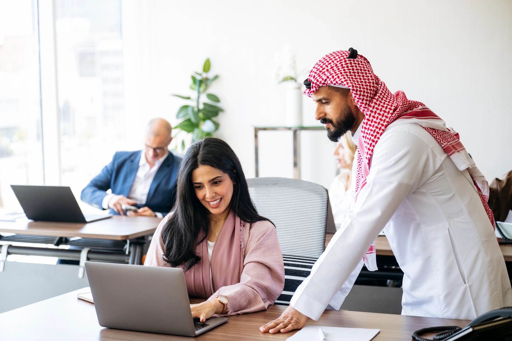 Two colleagues working together on a laptop