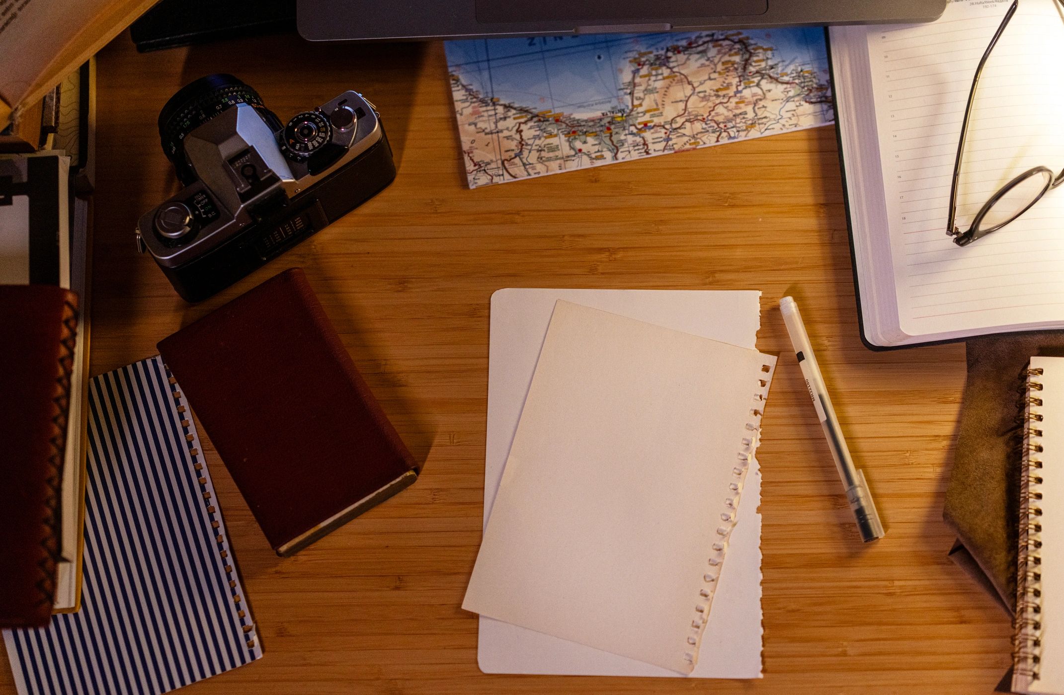 Workspace with map and laptop for planning an international move