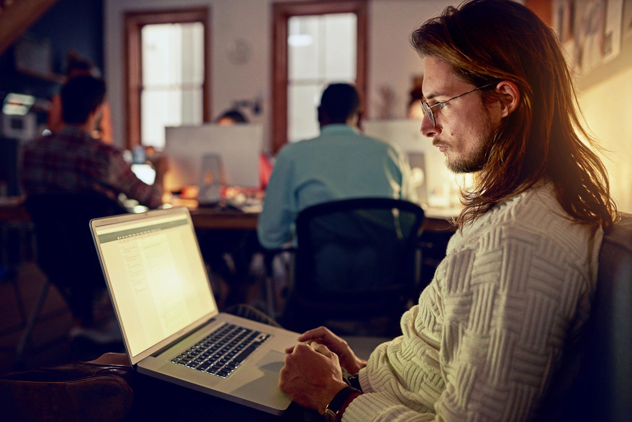 Professional working on a laptop in an office